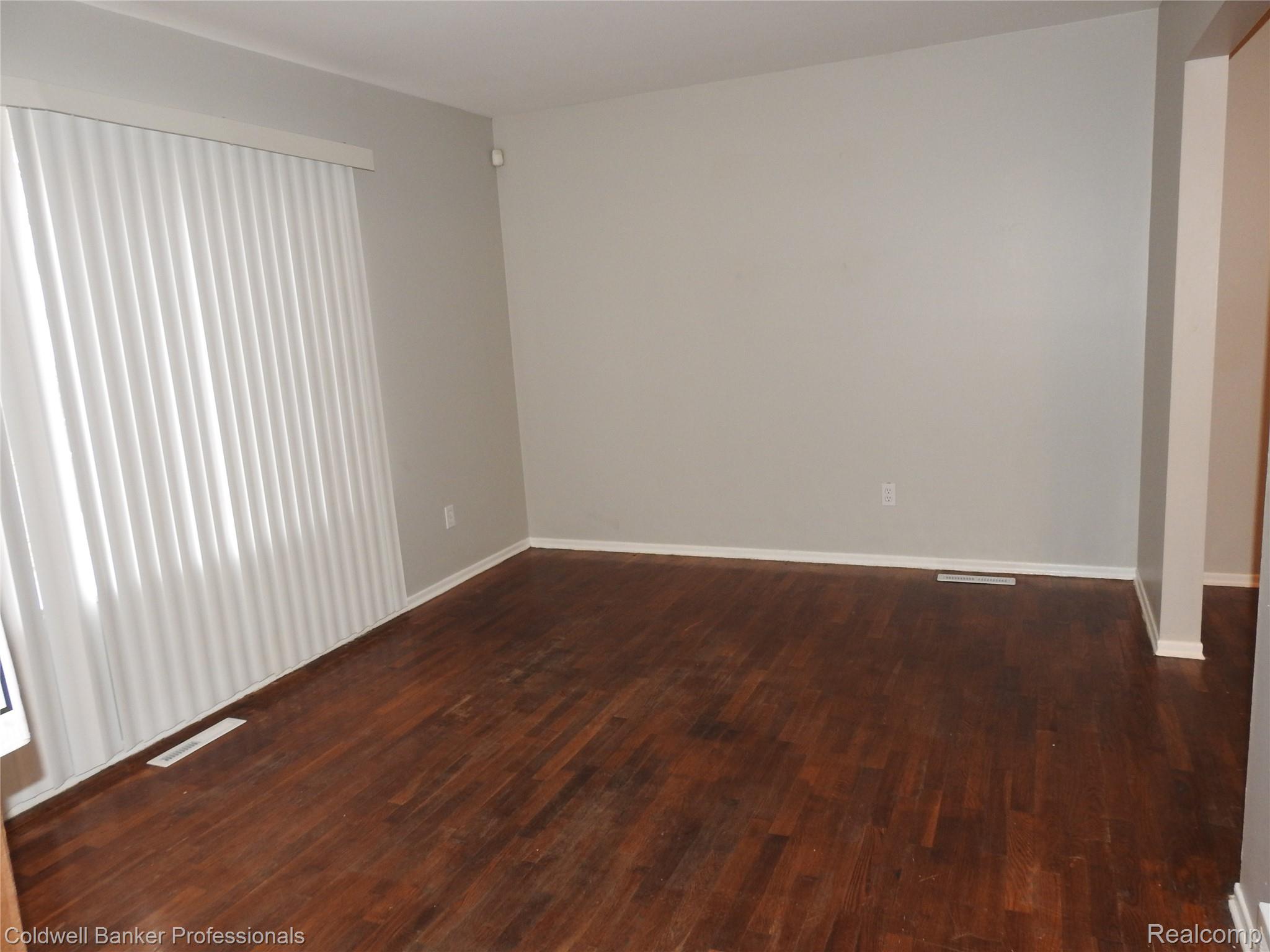 5919 Western Road Flint, MI 48506 - Photo 8 of 26 Empty room featuring dark wood-type flooring