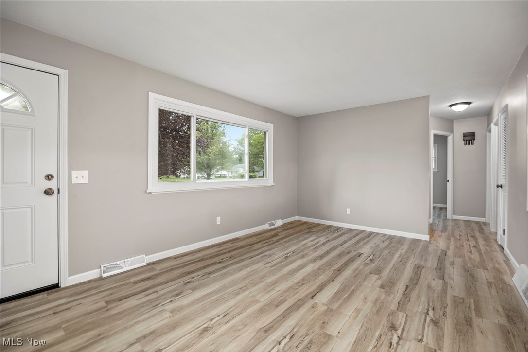 6265 Jaycox Road North Ridgeville, OH 44039 - Photo 6 of 39 Unfurnished living room featuring light wood-type flooring and baseboards