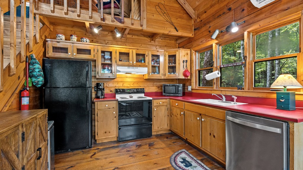 390 Butler Creek Road Cherry Log, GA 30522 - Photo 9 of 20 a kitchen with stainless steel appliances granite countertop a sink stove and refrigerator