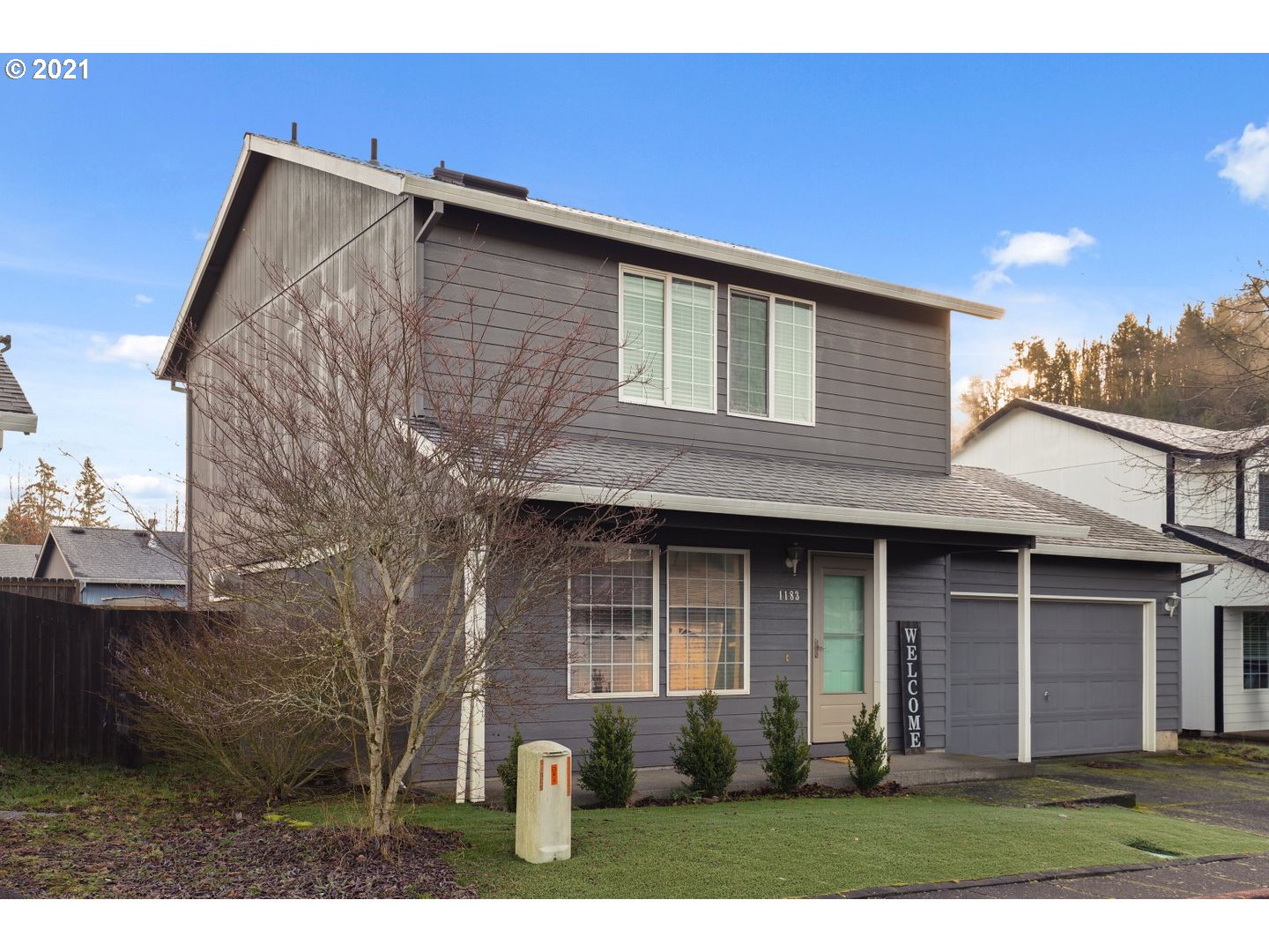 1183 Southwest Ivory Loop Gresham, OR 97080 - Photo 3 of 25 a front view of a house with a yard