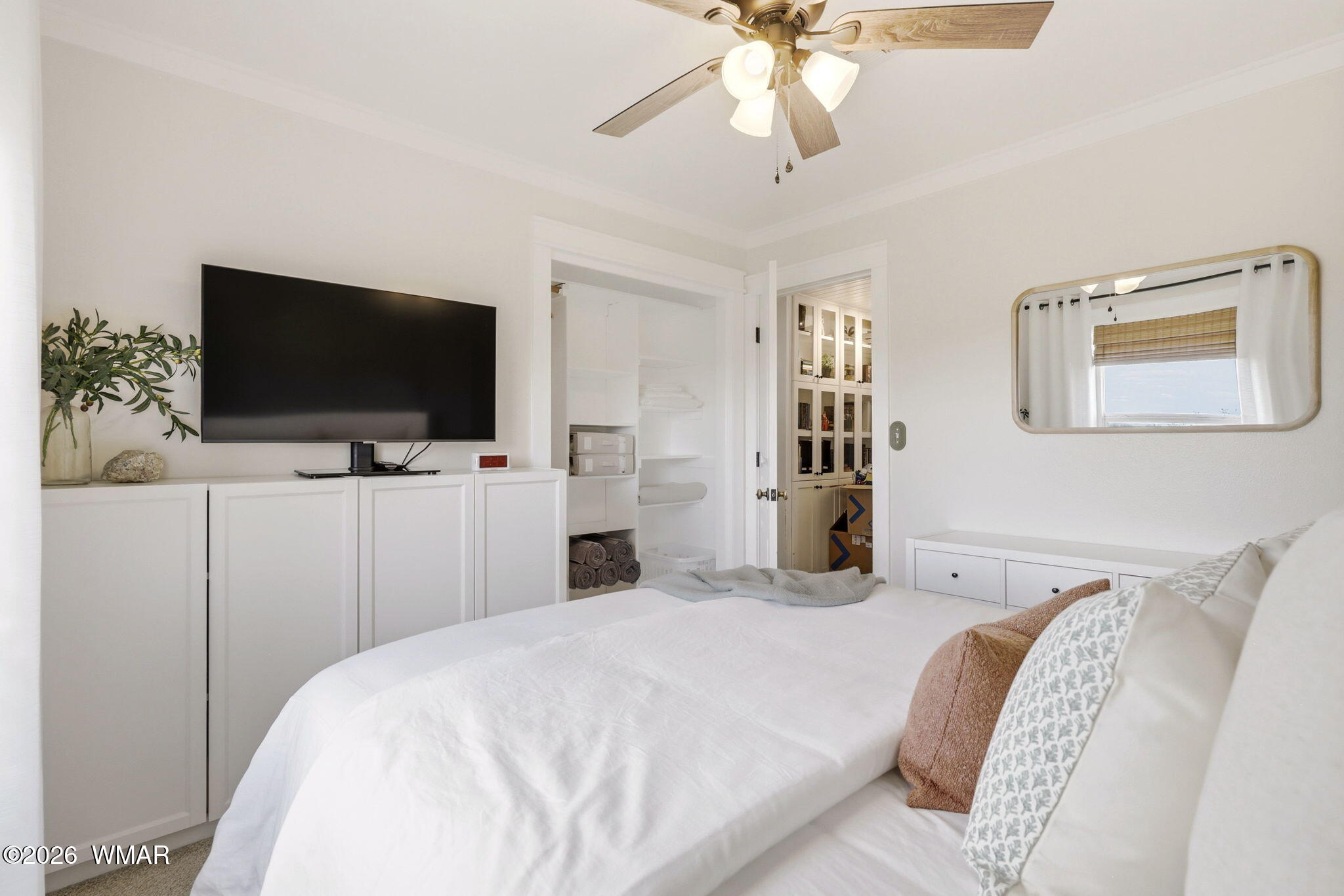 1491 Hunsaker Road Holbrook, AZ 86025 - Photo 17 of 40 a bedroom with a bed and a flat screen tv