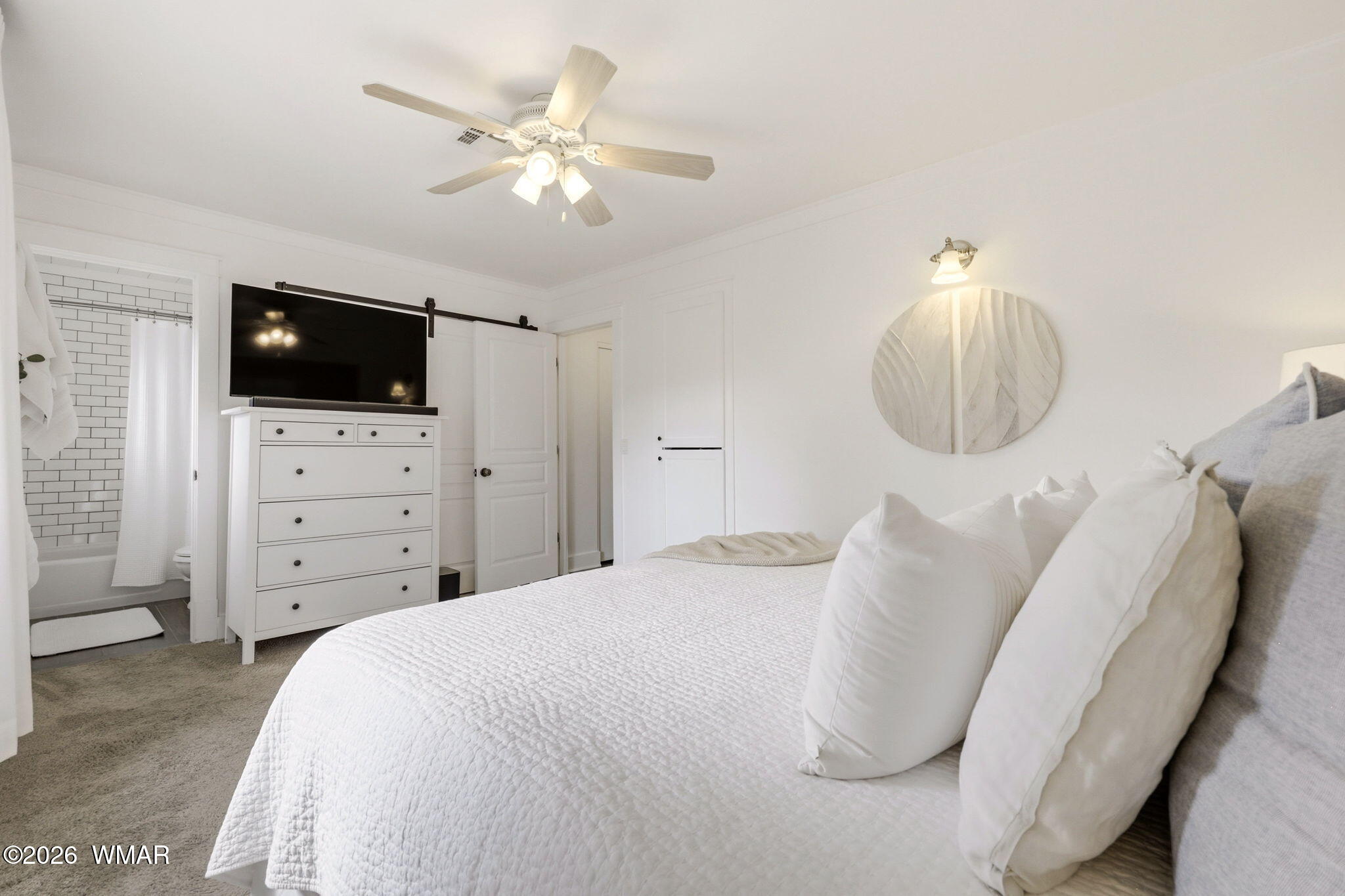 1491 Hunsaker Road Holbrook, AZ 86025 - Photo 22 of 40 a spacious bedroom with a bed and a flat screen tv