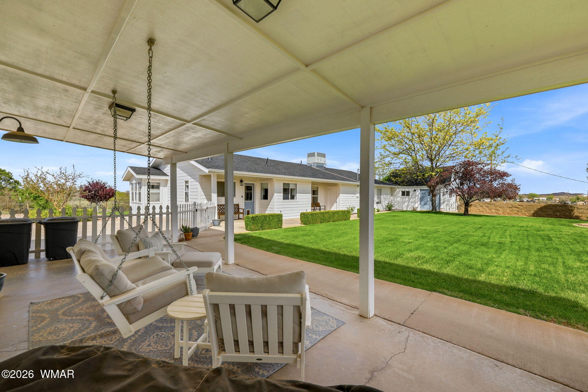 1491 Hunsaker Road Holbrook, AZ 86025 - Photo 30 of 40 a view of a patio with a table chairs and a small yard