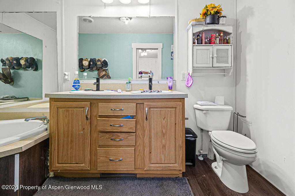 925 West 1st Street, Unit 511 Craig, CO 81625 - Photo 13 of 28 a bathroom with a toilet sink and mirror