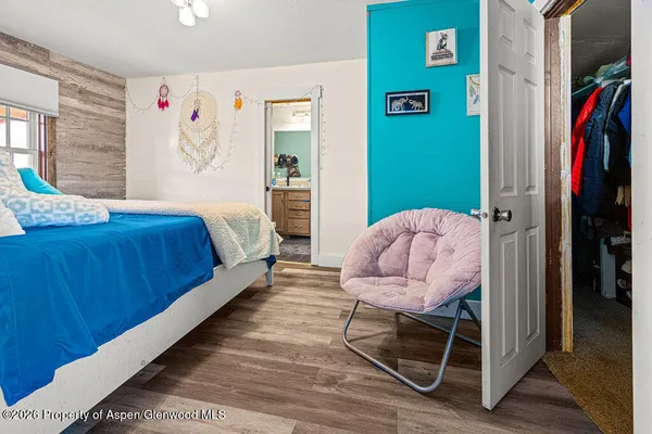 a bedroom with a bed and a chair