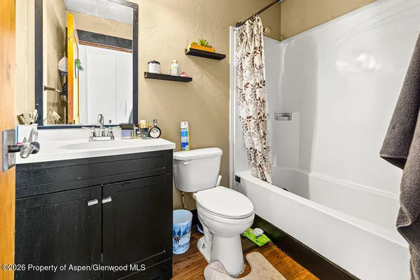 a bathroom with a sink toilet and shower