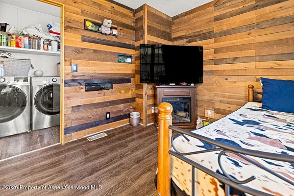a view of a living room with furniture and a flat screen tv