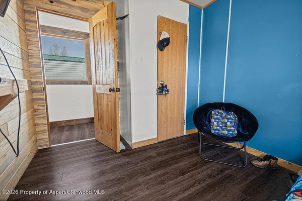 a view of a hallway with wooden floor and workspace