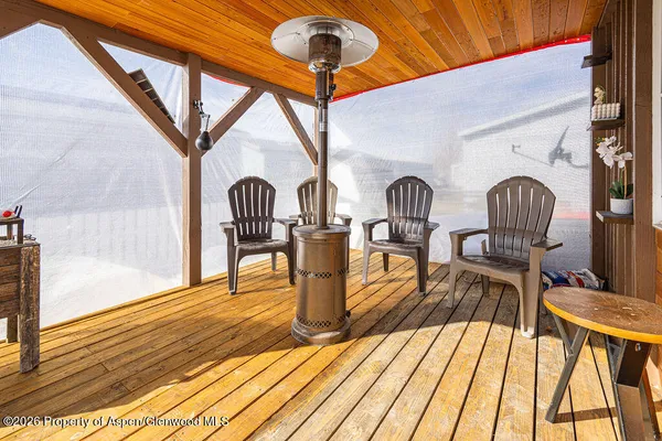 a living room with furniture a rug and wooden floor