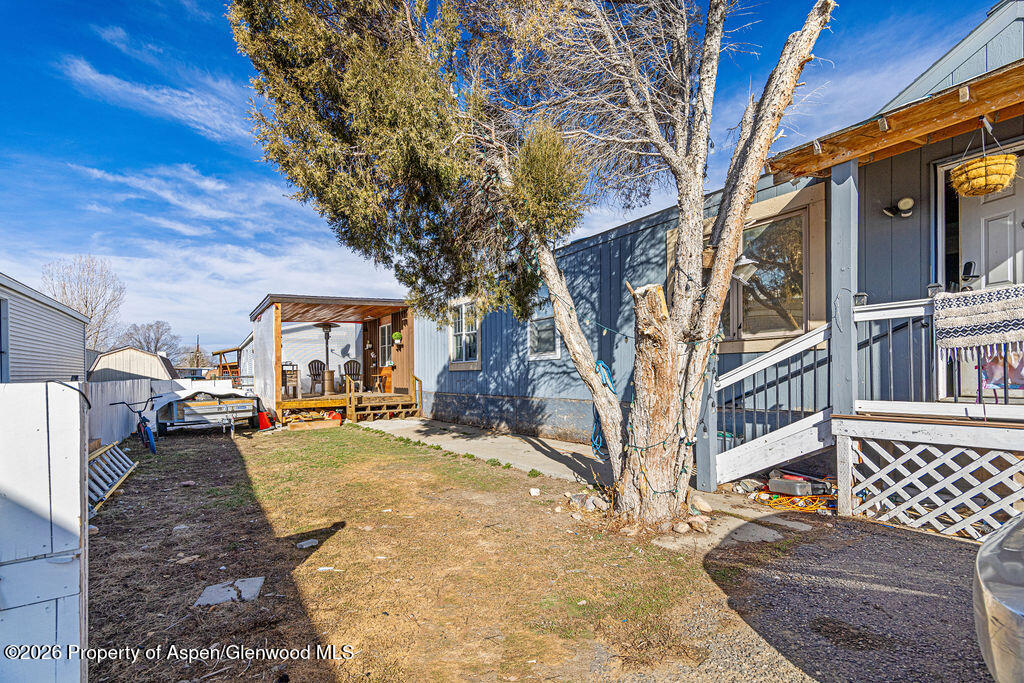925 West 1st Street, Unit 511 Craig, CO 81625 - Photo 25 of 28 a view of a backyard with a large tree
