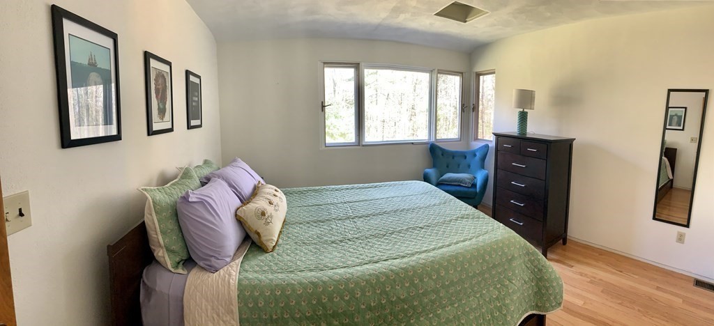 73 Bolton Road Harvard, MA 01451 - Photo 12 of 28 a bedroom with a bed and wooden floor
