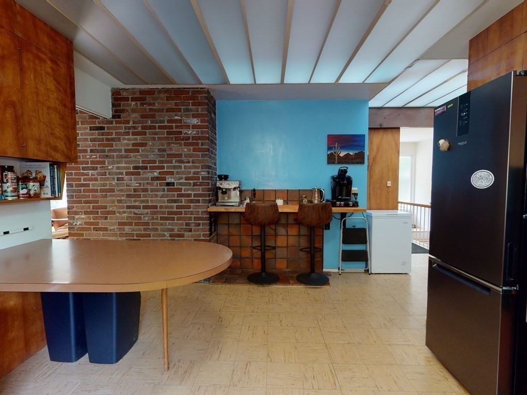 73 Bolton Road Harvard, MA 01451 - Photo 20 of 28 a kitchen with refrigerator and table