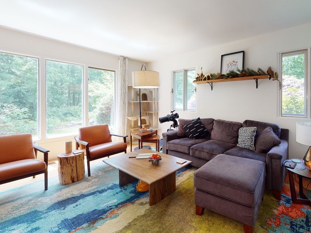 73 Bolton Road Harvard, MA 01451 - Photo 4 of 28 a living room with furniture a rug potted plant and a large window