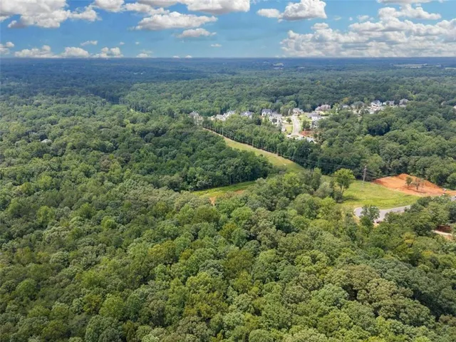 a view of a field of grass and trees