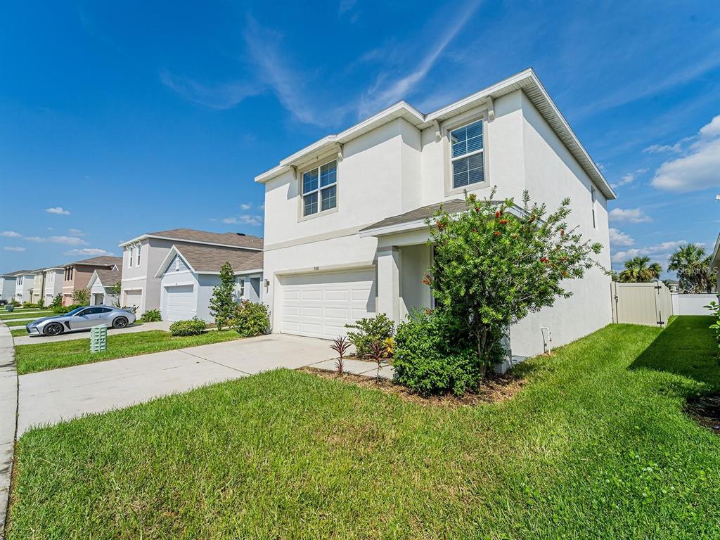 5510 Oxford Gray Road Wesley Chapel, FL 33545 - Photo 14 of 41 a front view of a house with a yard and garage