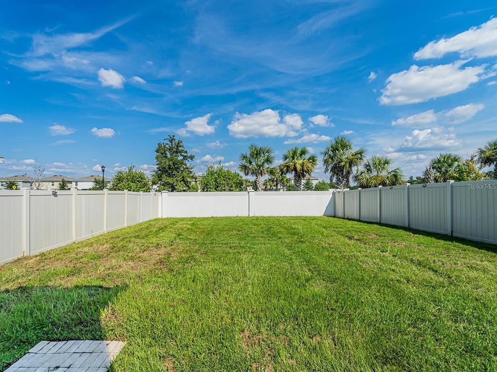 5510 Oxford Gray Road Wesley Chapel, FL 33545 - Photo 16 of 41 a view of yard with swimming pool and wooden fence