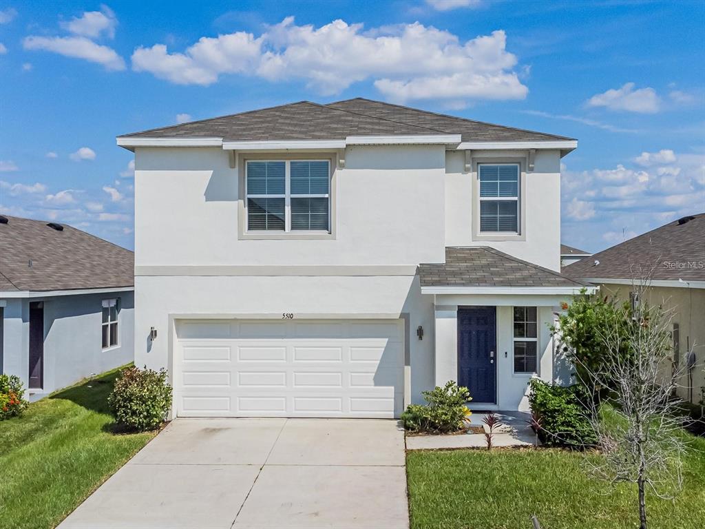 5510 Oxford Gray Road Wesley Chapel, FL 33545 - Photo 2 of 41 a front view of a house with a garden