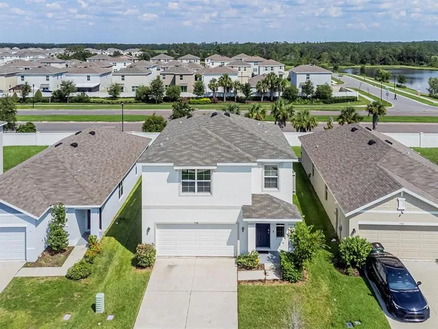 an aerial view of a house with a yard