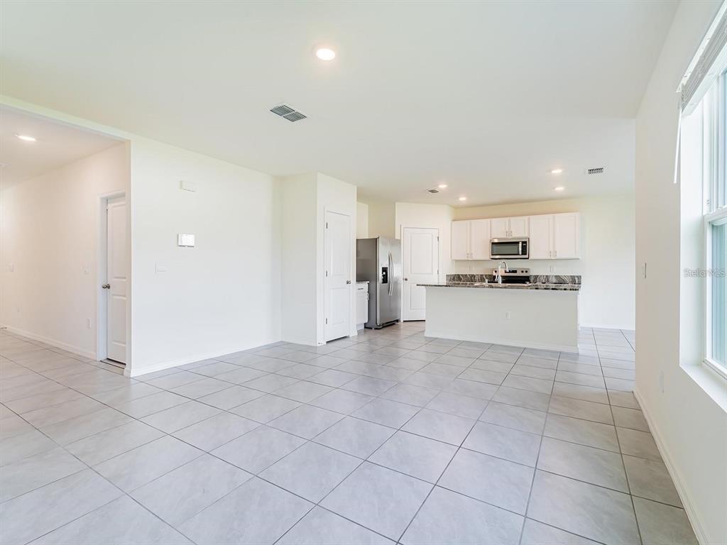5510 Oxford Gray Road Wesley Chapel, FL 33545 - Photo 33 of 41 a view of kitchen with granite countertop cabinets and refrigerator