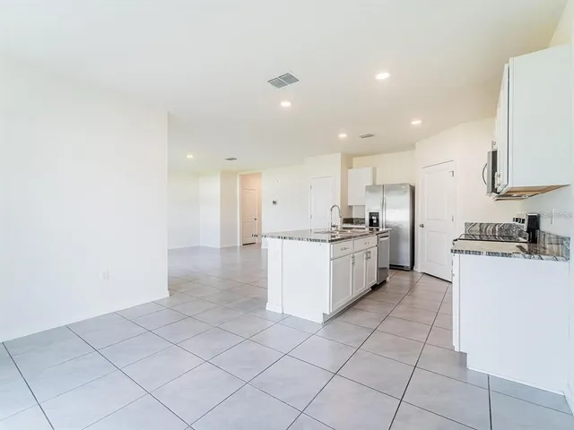 a kitchen with a sink a counter top space and cabinets