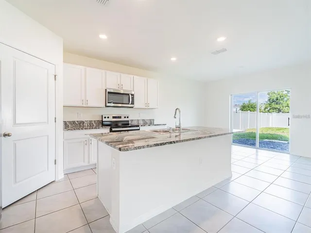 a kitchen with stainless steel appliances granite countertop a sink and a stove