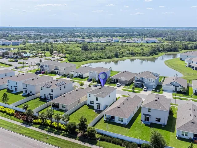 an aerial view of a houses with a lake