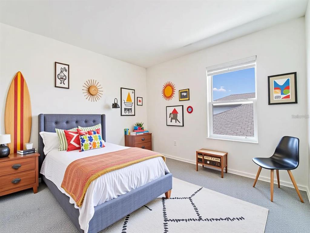 5510 Oxford Gray Road Wesley Chapel, FL 33545 - Photo 7 of 41 a bedroom with a bed a rug and a chair