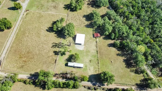 an aerial view of a house with a yard