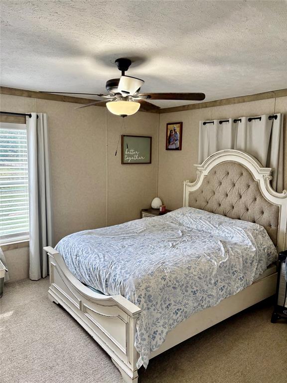 184 Fcr 941 Teague, TX 75860 - Photo 17 of 26 a bedroom with a bed and a ceiling fan