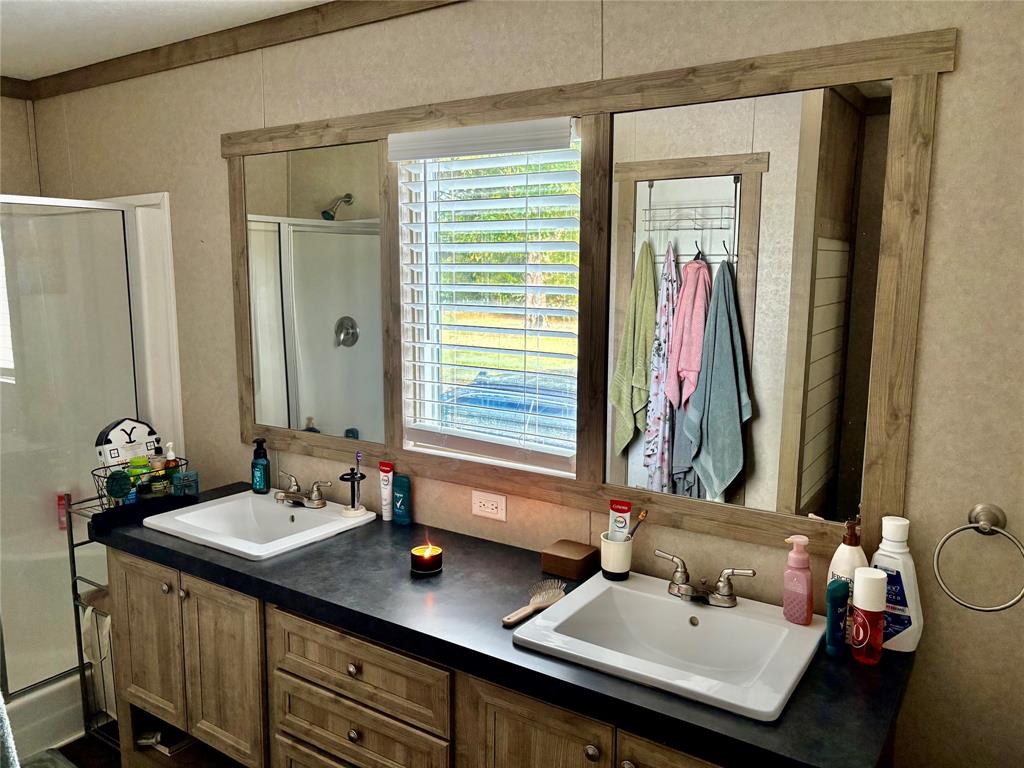 184 Fcr 941 Teague, TX 75860 - Photo 19 of 26 a bathroom with a sink and a mirror