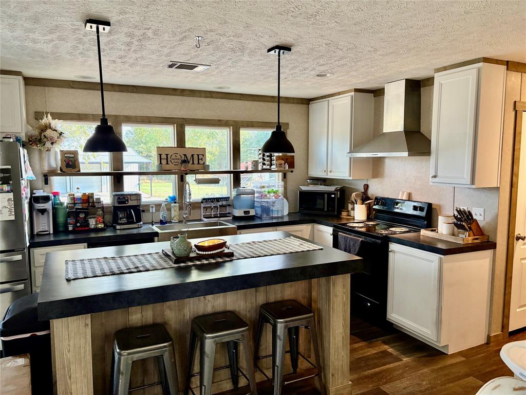 184 Fcr 941 Teague, TX 75860 - Photo 21 of 26 a kitchen with stainless steel appliances granite countertop a sink a stove and a wooden floors