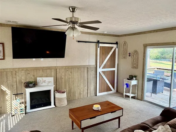 a living room with a flat screen tv and a fireplace