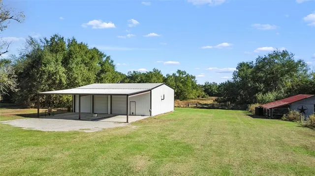 a view of a house with a yard and sitting area