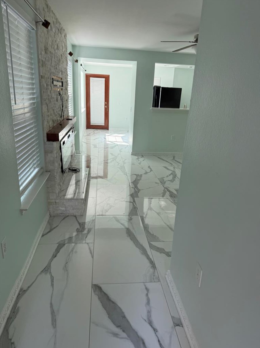 6600 Glebe Path Austin, TX 78754 - Photo 5 of 11 Refined tile flooring extends through this inviting space, leading to a contemporary electric fireplace feature.