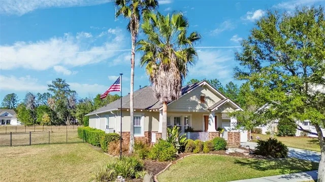a front view of a house with a yard and fountain