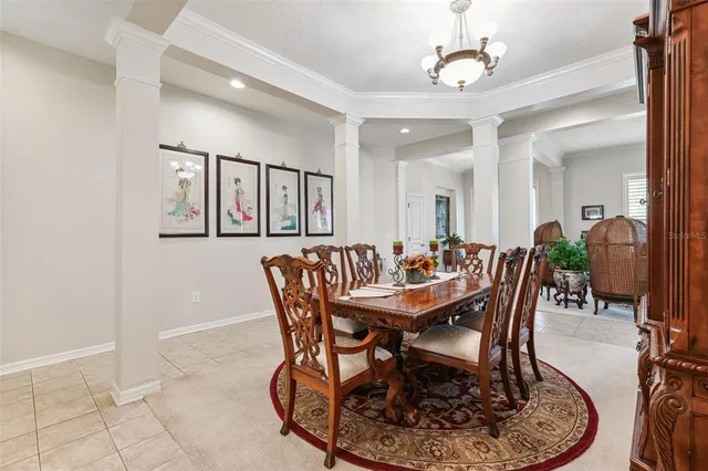 a kitchen with stainless steel appliances granite countertop a refrigerator a oven a sink a dining table and chairs