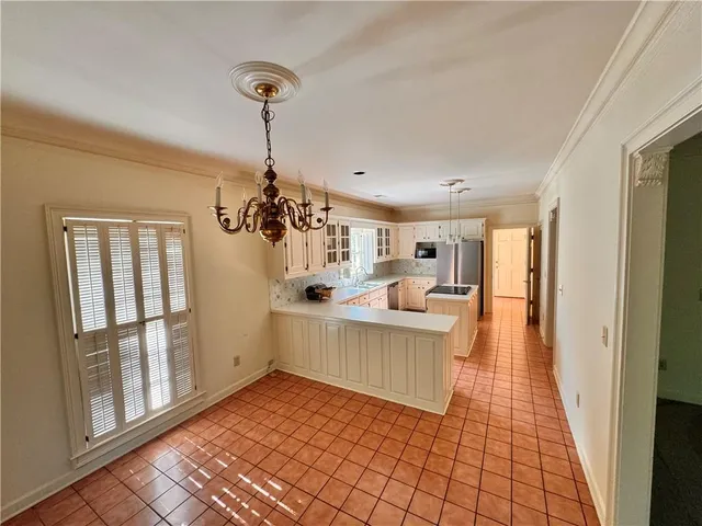 a view of a room with wooden floor and windows