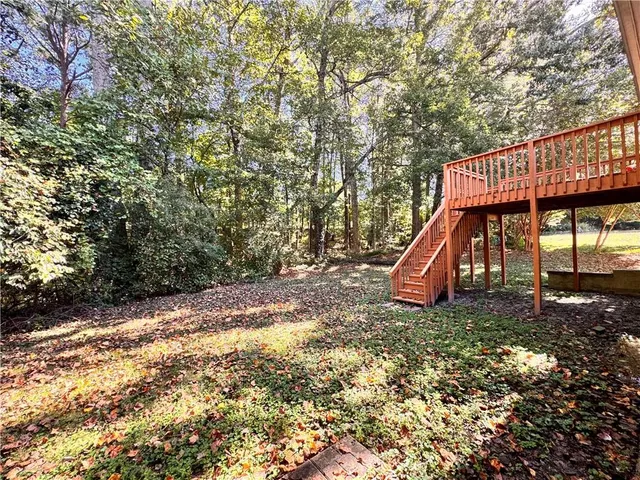 a view of a yard with wooden fence