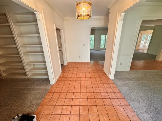 a view of an empty room with empty shelves