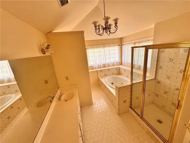a bathroom with a tub sink and mirror