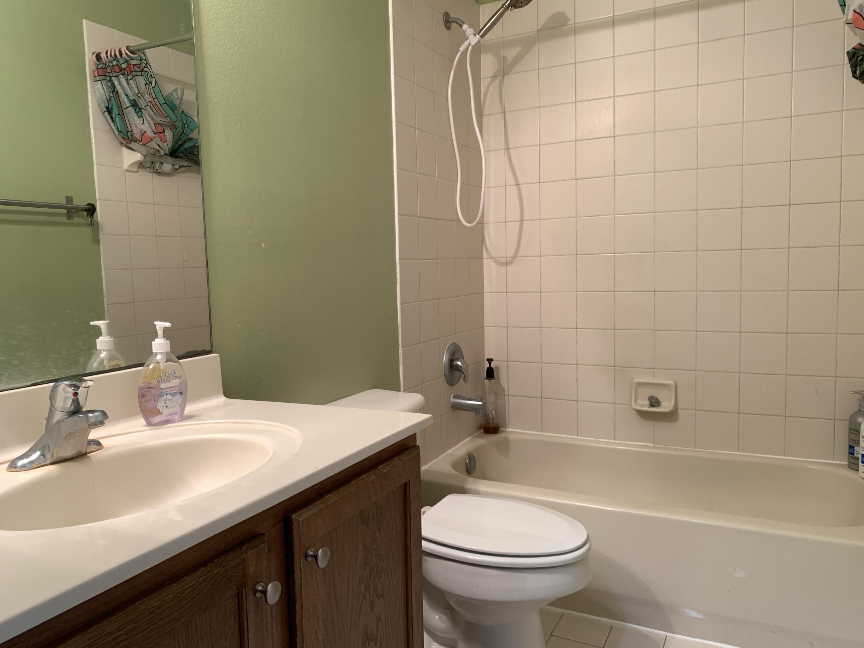 2304 Center Stone Lane Riviera Beach, FL 33404 - Photo 12 of 15 a bathroom with a sink a toilet and shower
