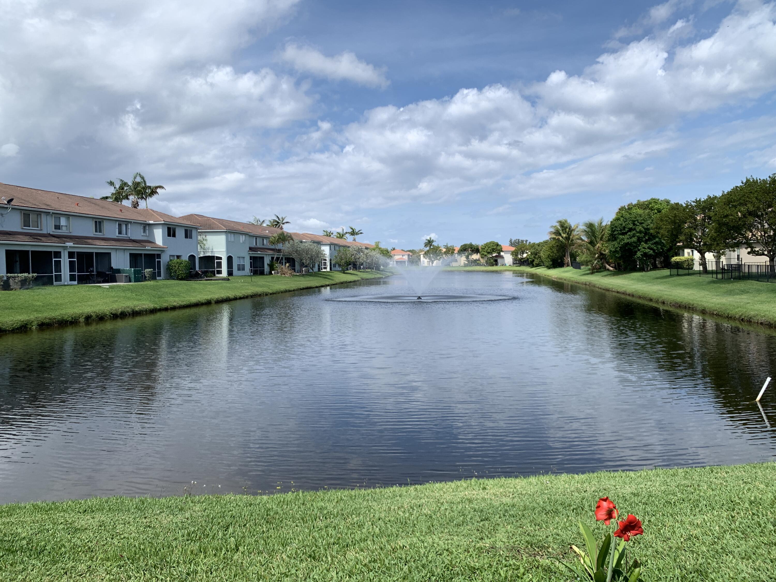 2304 Center Stone Lane Riviera Beach, FL 33404 - Photo 15 of 15 a view of a lake with a yard and large trees