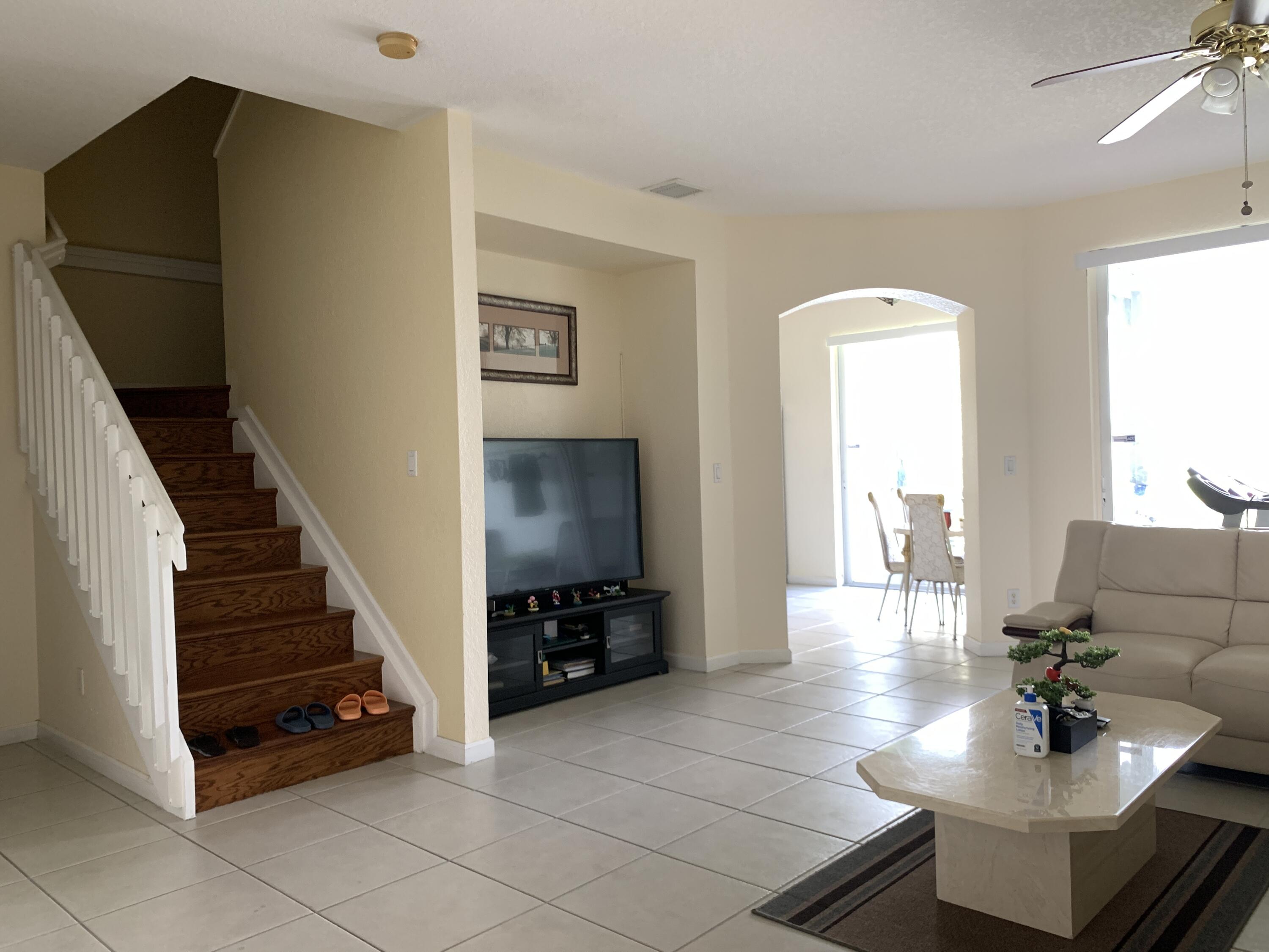 2304 Center Stone Lane Riviera Beach, FL 33404 - Photo 3 of 15 a living room with furniture and a flat screen tv