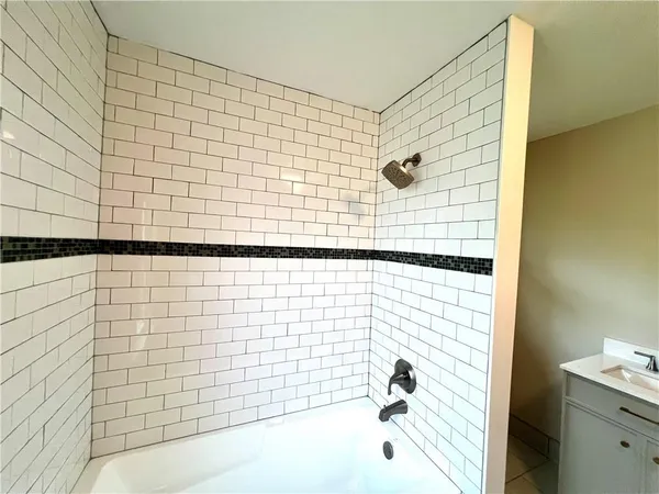 a bathroom with a bathtub and shower