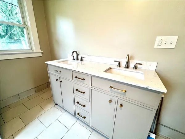 a bathroom with a sink vanity and mirror