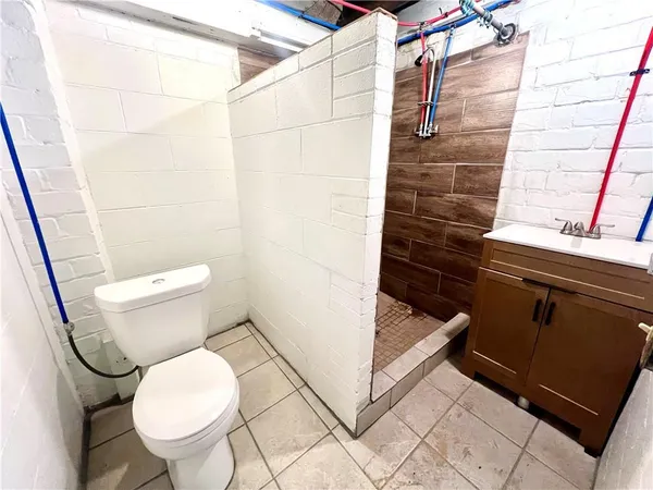 a bathroom with a toilet and a shower