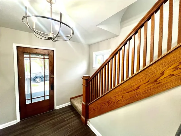 a view of a porch with wooden floor and windows