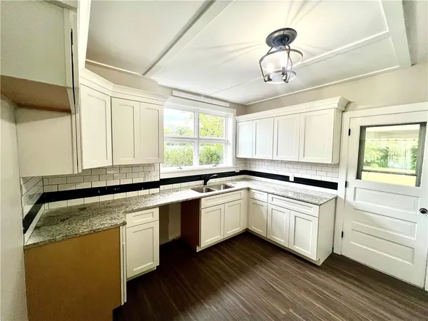 a kitchen with wooden cabinets and white appliances