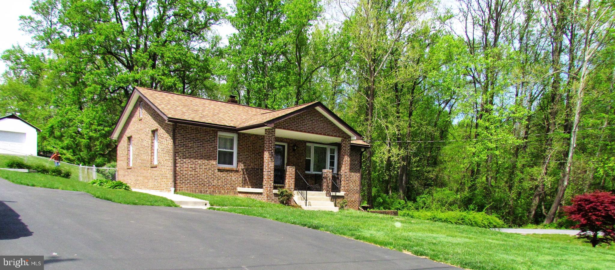 6442 Mt Phillip Road Frederick, MD 21703 - Photo 2 of 37 a front view of a house with yard and green space