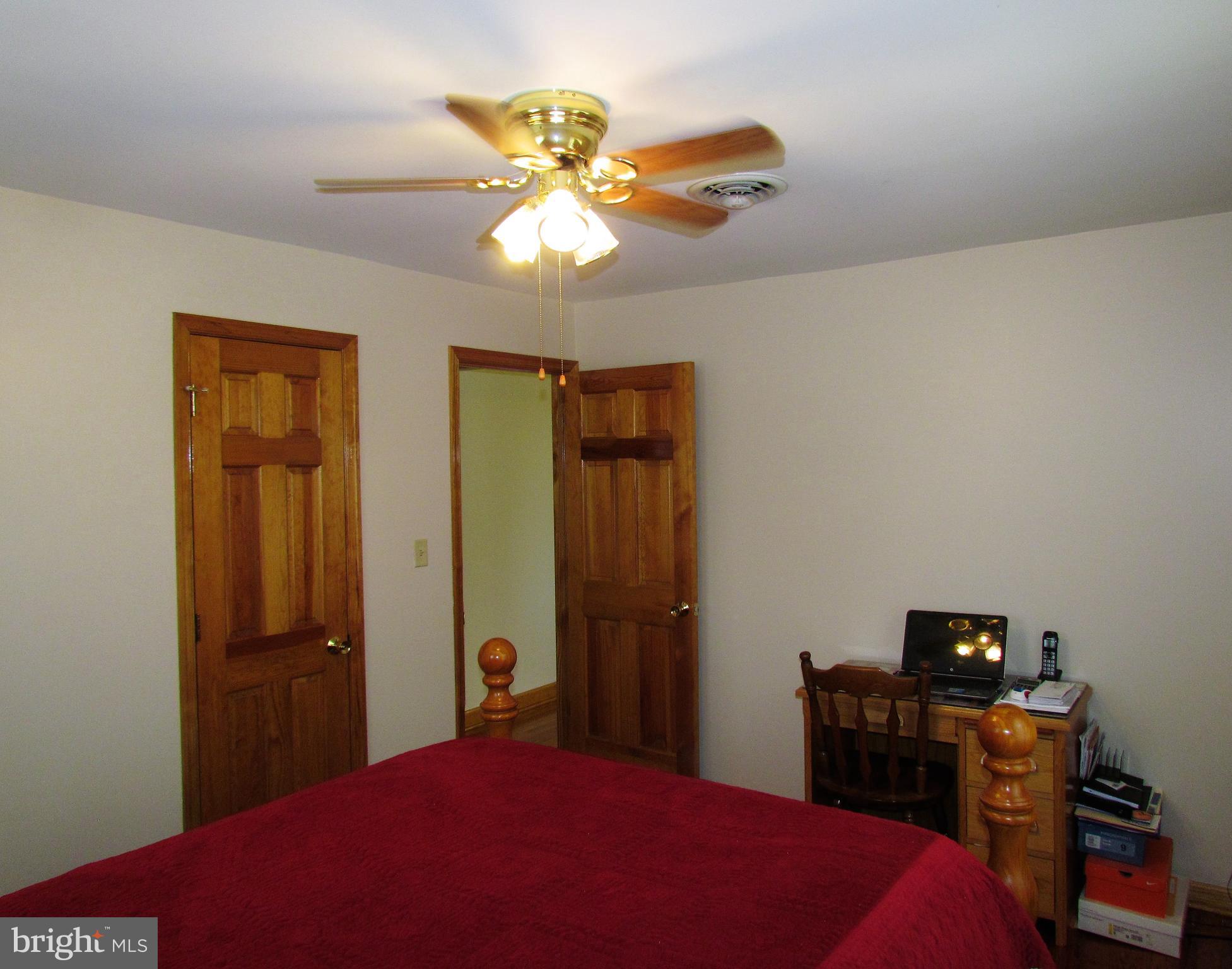 6442 Mt Phillip Road Frederick, MD 21703 - Photo 12 of 37 a bedroom with a bed and a chandelier